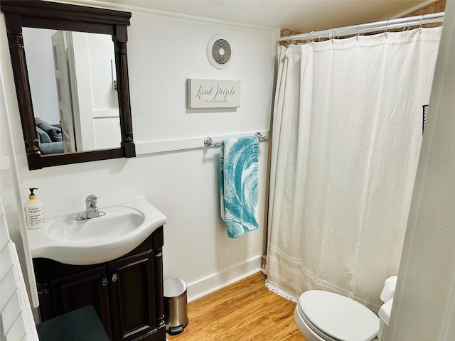 bathroom with hardwood / wood-style floors, vanity, and toilet