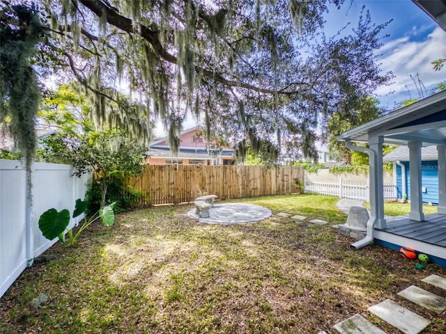 view of yard with a patio area and a wooden deck