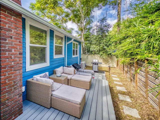 deck with an outdoor hangout area and area for grilling