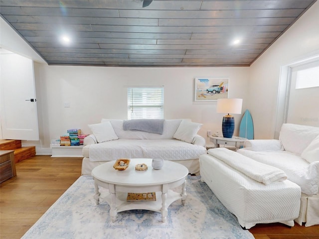 living room featuring wood ceiling, wood-type flooring, and ornamental molding