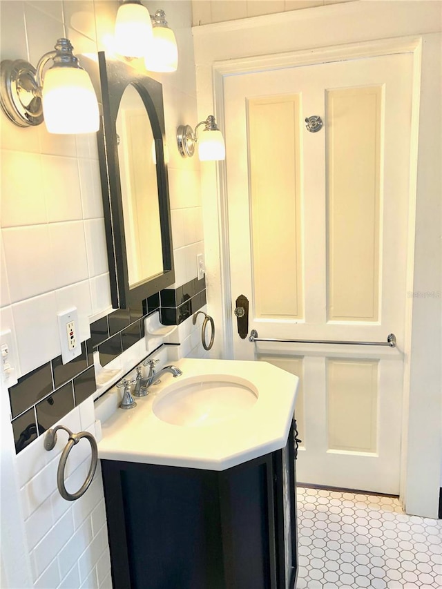 bathroom with decorative backsplash, tile walls, and vanity