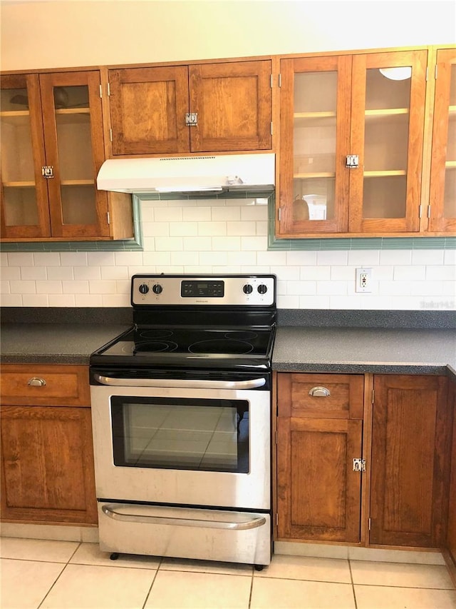 kitchen featuring tasteful backsplash, stainless steel range with electric cooktop, and light tile patterned flooring