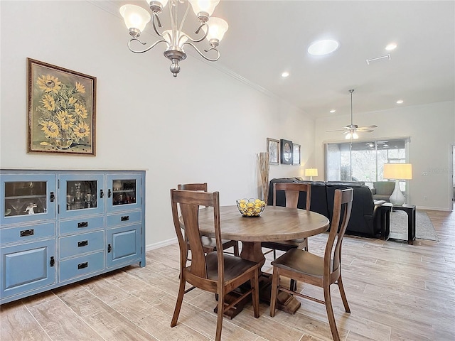 dining area featuring light wood-style floors, ornamental molding, baseboards, and ceiling fan with notable chandelier