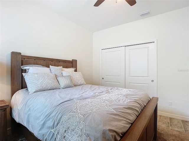 bedroom featuring baseboards, visible vents, a ceiling fan, vaulted ceiling, and a closet