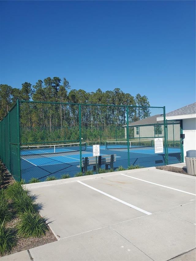 view of tennis court with fence