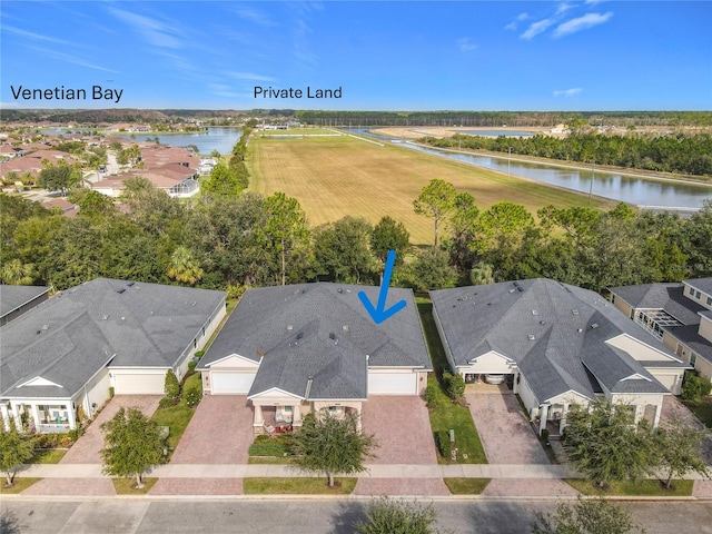 drone / aerial view with a water view and a residential view