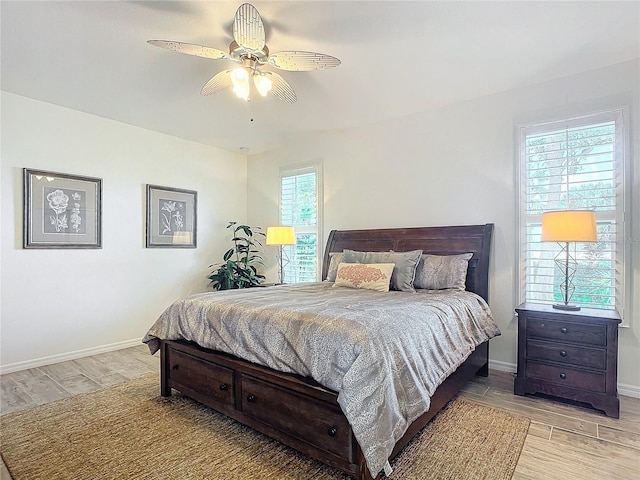 bedroom with wood tiled floor, baseboards, and ceiling fan