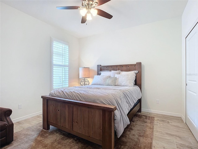 bedroom with baseboards, a ceiling fan, and wood finished floors