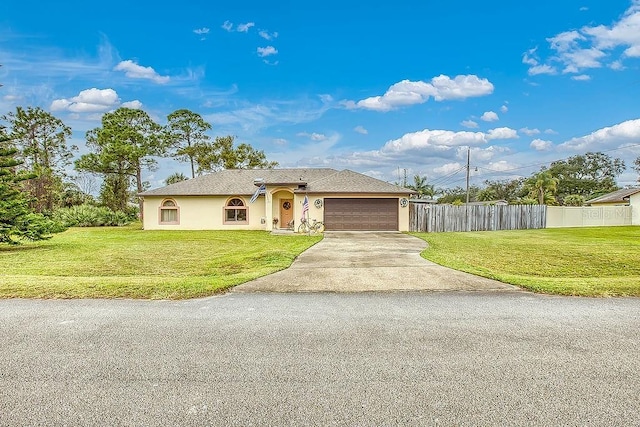 view of front of house with a front yard and a garage