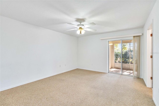 spare room with ceiling fan and light colored carpet