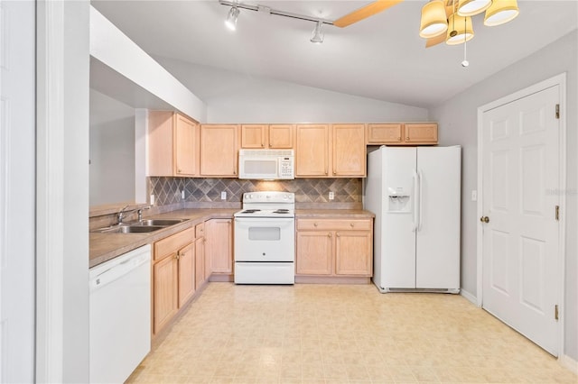 kitchen with lofted ceiling, sink, white appliances, and light brown cabinets