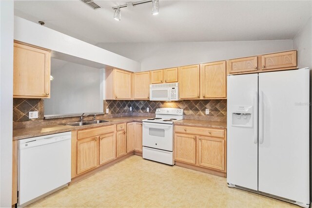 kitchen with white appliances, sink, vaulted ceiling, decorative backsplash, and light brown cabinetry