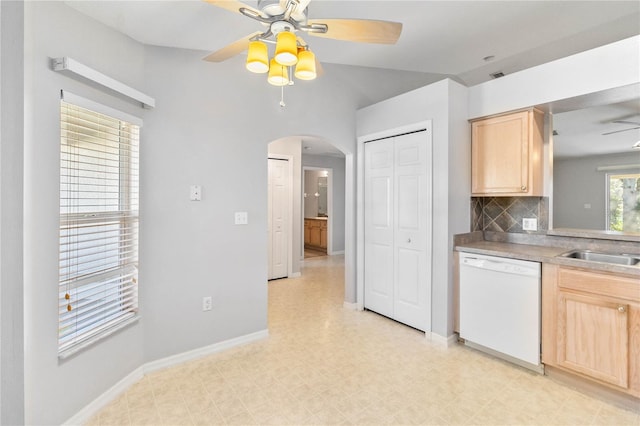 kitchen featuring backsplash, ceiling fan, light brown cabinetry, and white dishwasher