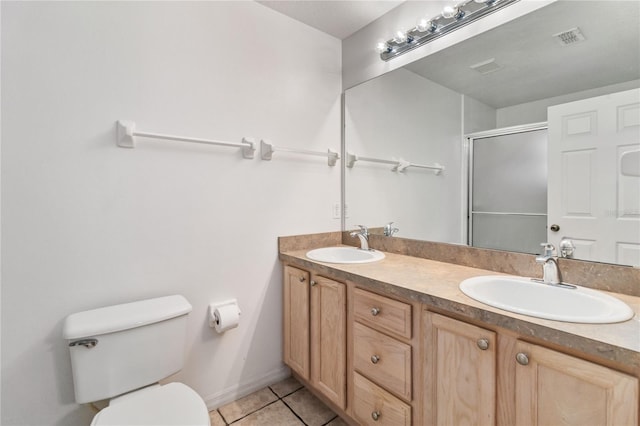 bathroom featuring toilet, tile patterned flooring, vanity, and walk in shower