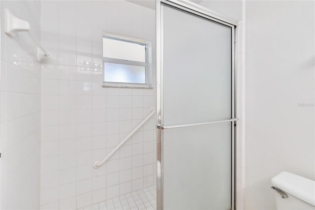 bathroom with toilet and walk in shower