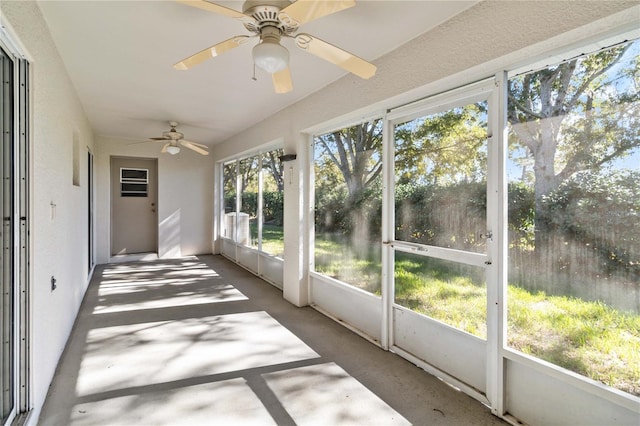 unfurnished sunroom with ceiling fan and a healthy amount of sunlight