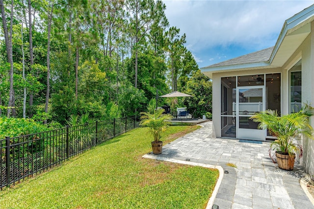 view of yard featuring a patio area and a sunroom