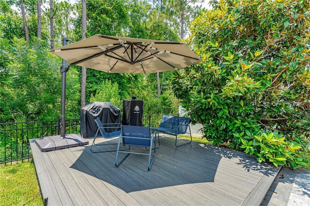 wooden terrace with a grill