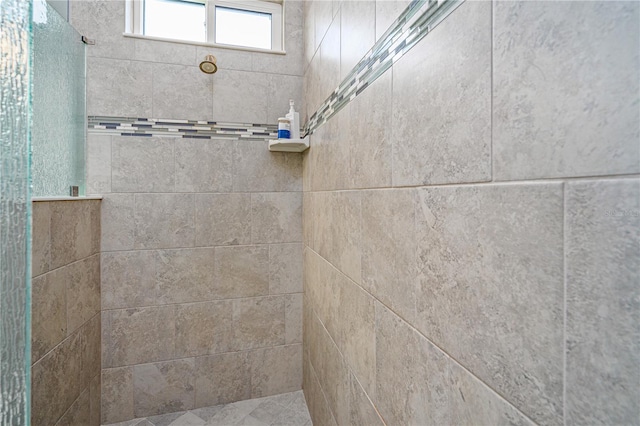 bathroom with a tile shower