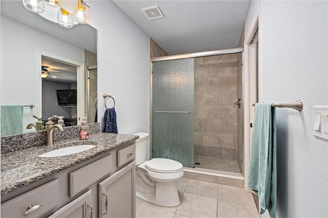 bathroom with vanity, a shower with door, tile patterned flooring, toilet, and a textured ceiling