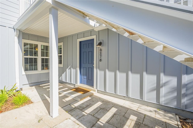 view of exterior entry with a porch