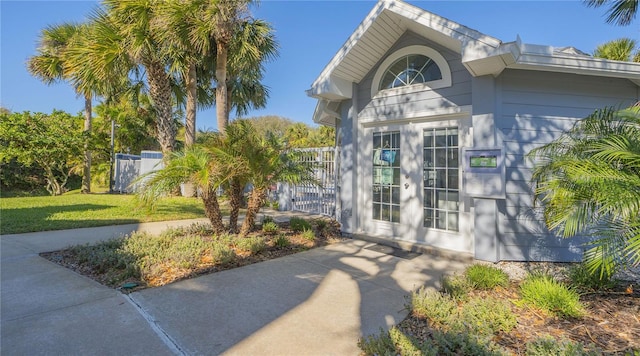 entrance to property with a lawn