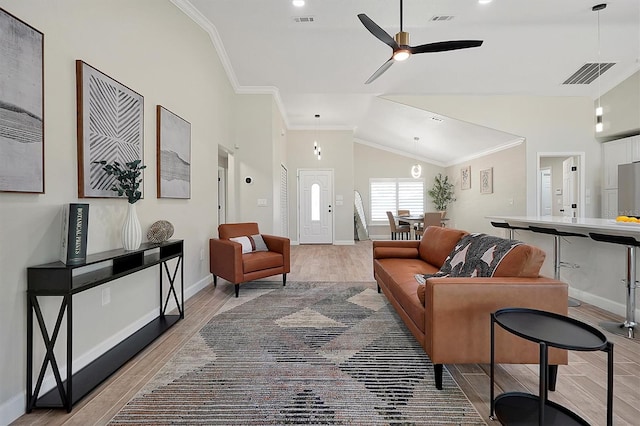 living room featuring vaulted ceiling, light hardwood / wood-style flooring, ceiling fan, and ornamental molding