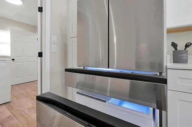 interior details featuring light hardwood / wood-style floors and white cabinetry