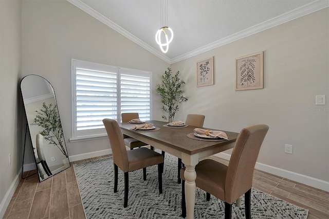 dining area with lofted ceiling, crown molding, and light hardwood / wood-style flooring