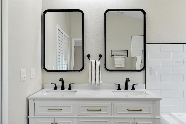 bathroom with vanity and a bathtub