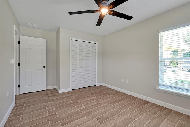 unfurnished bedroom featuring ceiling fan, light hardwood / wood-style floors, and a closet