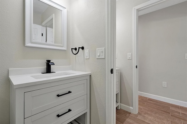 bathroom featuring vanity and wood-type flooring