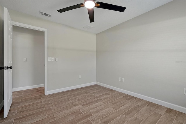 spare room featuring light hardwood / wood-style floors and ceiling fan