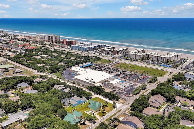 bird's eye view with a water view and a beach view