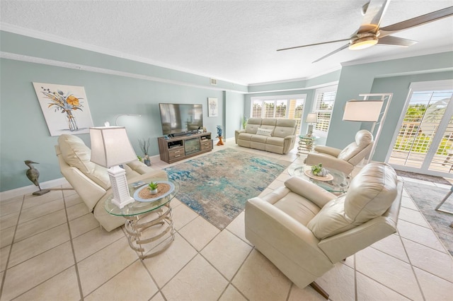 living room with light tile patterned floors, a healthy amount of sunlight, and a textured ceiling