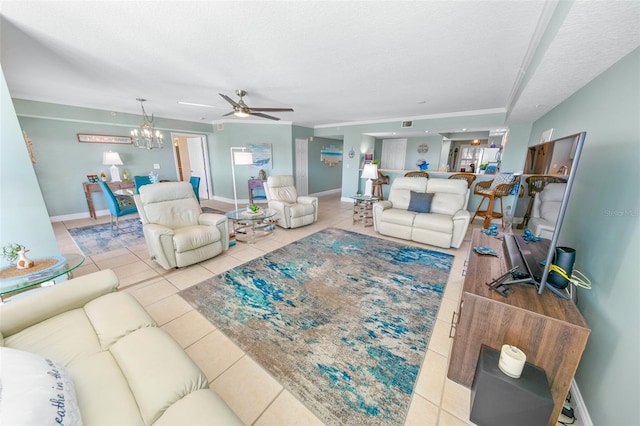 tiled living room featuring ceiling fan with notable chandelier and a textured ceiling