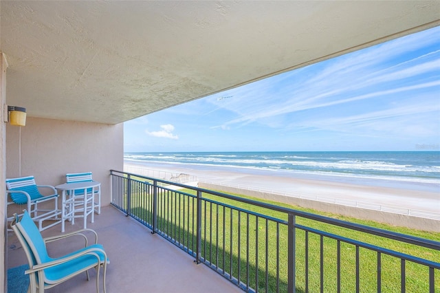 balcony with a view of the beach and a water view