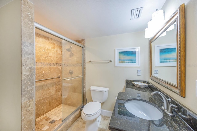 bathroom with tile patterned flooring, vanity, a shower with shower door, and toilet