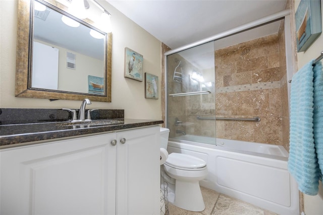 full bathroom featuring tile patterned floors, vanity, toilet, and shower / bath combination with glass door