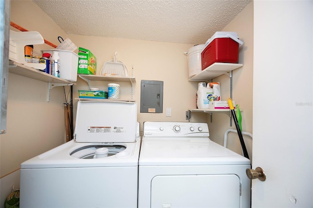 washroom with separate washer and dryer, a textured ceiling, and electric panel