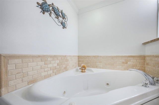 bathroom with crown molding and a tub