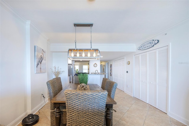 tiled dining space with crown molding and sink