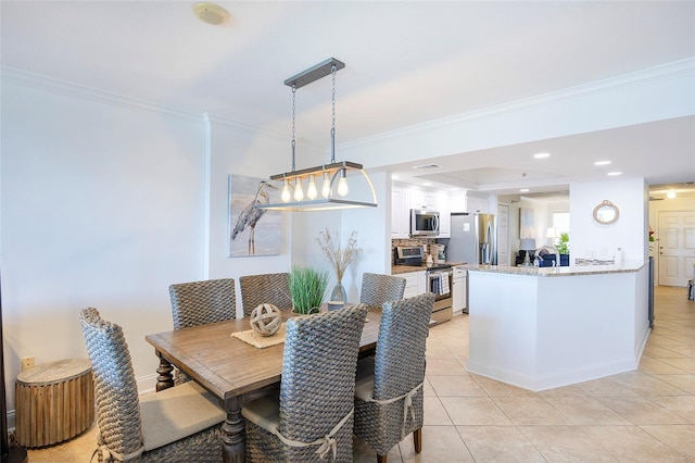 tiled dining area featuring crown molding