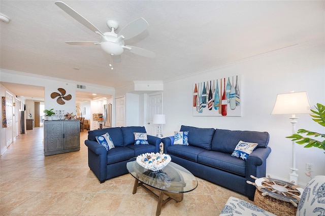 living room featuring ceiling fan and ornamental molding