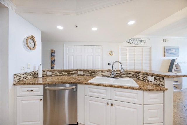 kitchen with kitchen peninsula, white cabinets, crown molding, sink, and dishwasher