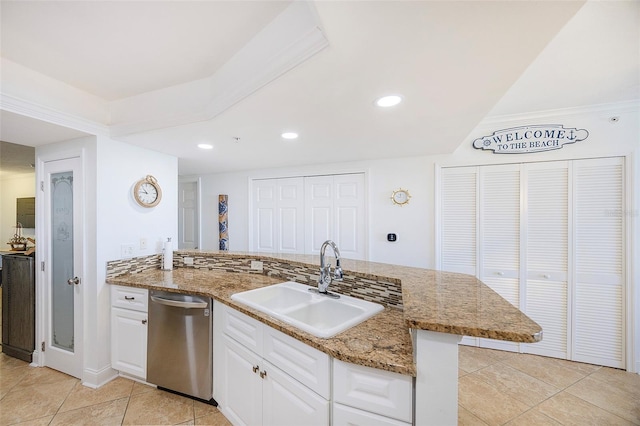 kitchen featuring dishwasher, sink, light tile patterned floors, kitchen peninsula, and white cabinets