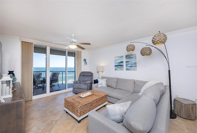 living room featuring floor to ceiling windows, crown molding, and a water view