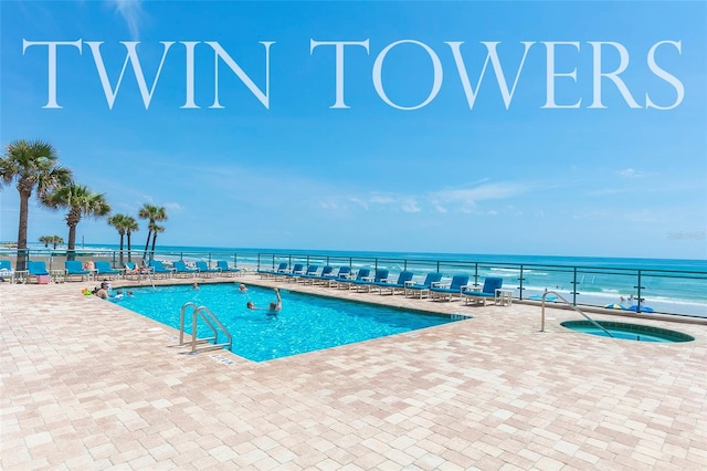 view of swimming pool with a community hot tub, a water view, and a patio area