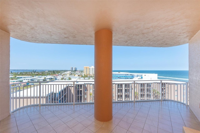 balcony featuring a water view and a view of the beach