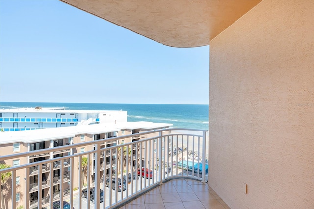 balcony featuring a water view and a view of the beach